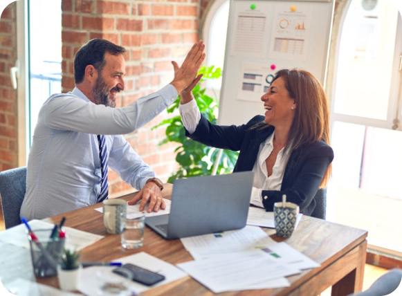 employees joyfully giving high five to each other